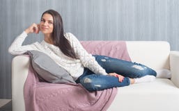 Relaxing on couch, sofa at home, comfort. cute young woman smiling, stock image Relaxing on couch, sofa at home, comfort. cute young woman smiling, stock image