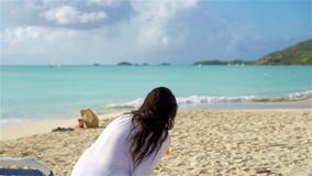 Relaxing and enjoying on summer vacation, woman lying in sunbed on beach. SLOW MOTION stock footage Relaxing and enjoying on summer vacation, woman lying in sunbed on beach. SLOW MOTION stock footage