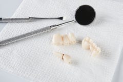 Removed wisdom tooth on white napkin and dental equipment stock images Removed wisdom tooth on white napkin and dental equipment stock images