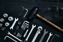Renovating a car. A set of repair tools- hex keys, a hammer and a screwdriver on a black wooden background. Close up stock photography Renovating a car. A set of repair tools- hex keys, a hammer and a screwdriver on a black wooden background. Close up stock photography