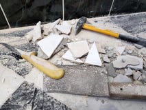 Repair - building with tools hammer, sledgehammer, cleaver and a knife with shards of tile stock image Repair - building with tools hammer, sledgehammer, cleaver and a knife with shards of tile stock image