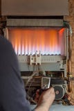 Repair of a gas boiler, setting up and servicing by a service department. Adjustment of gas pressure by manometer royalty free stock photo Repair of a gas boiler, setting up and servicing by a service department. Adjustment of gas pressure by manometer royalty free stock photo