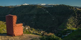 Red arm chair perched on hillside,Sacromonte caves,Granada,Andalucia,Spain royalty free stock images Red arm chair perched on hillside,Sacromonte caves,Granada,Andalucia,Spain royalty free stock images