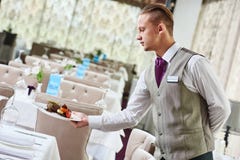 Restaurant waiter serving table with food Stock Photo Restaurant waiter serving table with food Stock Photo