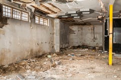 Resti dell'abbandonato di interno nocivo e distrutto della casa dalla granata che sguscia con il tetto e la parete crollati nel s immagini stock Resti dell'abbandonato di interno nocivo e distrutto della casa dalla granata che sguscia con il tetto e la parete crollati nel s immagini stock
