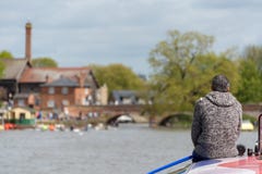 Man on roof of boat with blurred river scene in background royalty free stock images Man on roof of boat with blurred river scene in background royalty free stock images