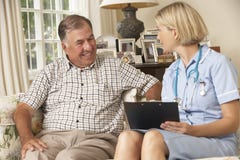 Retired Senior Man Having Health Check With Nurse At Home royalty free stock images Retired Senior Man Having Health Check With Nurse At Home royalty free stock images