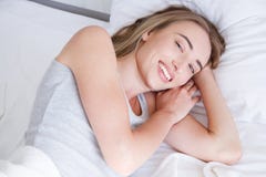 Retrato de la mujer hermosa que despierta en su cama blanca y que bosteza Resto, el dormir, gente y concepto de la comodidad imagenes de archivo Retrato de la mujer hermosa que despierta en su cama blanca y que bosteza Resto, el dormir, gente y concepto de la comodidad imagenes de archivo