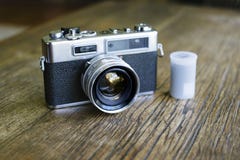 Retro Camera Beside a Film Canister stock photo Retro Camera Beside a Film Canister stock photo