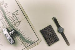 Retro camera is on the old map. Passport with a wristwatch is on the table. Summer voyage royalty free stock images Retro camera is on the old map. Passport with a wristwatch is on the table. Summer voyage royalty free stock images