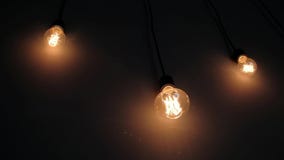 Retro light bulbs of the Edison, on dark wall, loft design