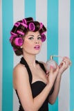 Retro pin up girl spraying perfume with hair rollers royalty free stock photography Retro pin up girl spraying perfume with hair rollers royalty free stock photography