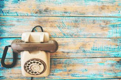 Retro technology of vintage telephone on blue paint color wood table. stock image Retro technology of vintage telephone on blue paint color wood table. stock image