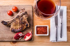 Rib Eye Steak On Chopping Board With Glass Of Wine Stock Images
