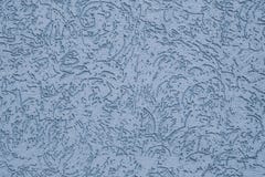 The ribbed pastel surface of concrete wall. Abstract pattern on blue wall. Embossed of stucco. Texture of paint on grooved plaster royalty free stock image The ribbed pastel surface of concrete wall. Abstract pattern on blue wall. Embossed of stucco. Texture of paint on grooved plaster royalty free stock image