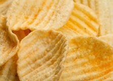 Ribbed potatoes snack with pepper on black background. Close up stock photo Ribbed potatoes snack with pepper on black background. Close up stock photo