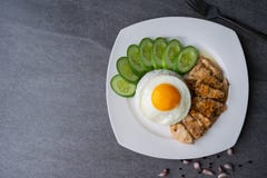 Rice,Fried egg,Fried chicken with garlic and black pepper in white dish on the concrete table royalty free stock image Rice,Fried egg,Fried chicken with garlic and black pepper in white dish on the concrete table royalty free stock image
