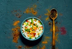 Rice with vegetables and spices on dark blue concrete background. Vegetarian food, products for proper nutrition, close up royalty free stock photos Rice with vegetables and spices on dark blue concrete background. Vegetarian food, products for proper nutrition, close up royalty free stock photos