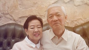 Rich Asian senior parents sit in luxury beautiful house background royalty free stock image Rich Asian senior parents sit in luxury beautiful house background royalty free stock image