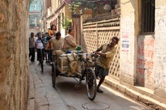 Rickshaw-puller carrying goods on the road of Kolkata Stock Photo Rickshaw-puller carrying goods on the road of Kolkata Stock Photo