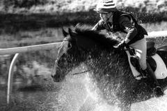 Riding horse through water at three day event