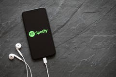 Riga, Latvia - March 25, 2018: Latest generation iPhone X with Spotify logo on the screen.