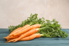 Ripe carrots on wooden table against light background stock image Ripe carrots on wooden table against light background stock image