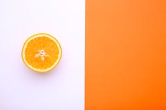 A ripe orange fruit on a colorful background. Half of orange. royalty free stock photography A ripe orange fruit on a colorful background. Half of orange. royalty free stock photography