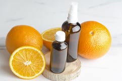 Ripe oranges and brown cosmetics bottles on wooden board.Concept of orange oil and cosmetics procedures royalty free stock photo Ripe oranges and brown cosmetics bottles on wooden board.Concept of orange oil and cosmetics procedures royalty free stock photo