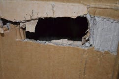 Ripped hole in cardboard royalty free stock images Ripped hole in cardboard royalty free stock images