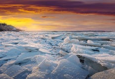 River in frosty winter sunset. Ice on river in frosty winter sunset River in frosty winter sunset. Ice on river in frosty winter sunset