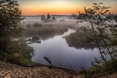 River In The Fog, Just Before Sunrise. A Warm Glow In The Clouds From The First Rays Of The Sun. Royalty Free Stock Photos