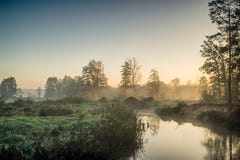 River In The Fog, Just Before Sunrise. A Warm Glow In The Clouds From The First Rays Of The Sun. Stock Images