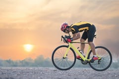 Road bike cyclist man cycling. Biking sports fitness athlete riding bike on an open road to the sunset. stock image Road bike cyclist man cycling. Biking sports fitness athlete riding bike on an open road to the sunset. stock image