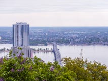 Road bridge between the cities of Saratov and Engels. Urban landscape, architecture. Multi-storey building. Blooming lilac bushes in the foreground Royalty Free Stock Photo Road bridge between the cities of Saratov and Engels. Urban landscape, architecture. Multi-storey building. Blooming lilac bushes in the foreground Royalty Free Stock Photo