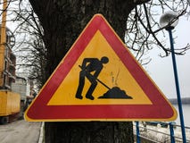 Road repair sign. Street road under construction. Road signs on the roadside along the road warning about the repair. Stock Photo Road repair sign. Street road under construction. Road signs on the roadside along the road warning about the repair. Stock Photo