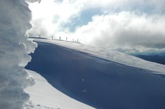 Road signs on a snow-covered mountain. A line of road signs dwarfed by a snow-covered mountain. A snow-covered sign frames the shot. Deep shadows of blue run Stock Image Road signs on a snow-covered mountain. A line of road signs dwarfed by a snow-covered mountain. A snow-covered sign frames the shot. Deep shadows of blue run Stock Image