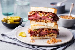 Roast beef sandwich on a plate with pickles. Stock Image Roast beef sandwich on a plate with pickles. Stock Image