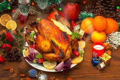 Christmas Dinner. Roasted chicken. Winter Holiday table served. Wooden background. Close-up. Top view stock image Christmas Dinner. Roasted chicken. Winter Holiday table served. Wooden background. Close-up. Top view stock image