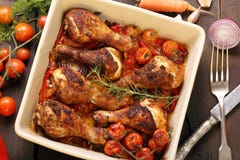 Roasted chicken drumsticks with vegetables in a pan Stock Images Roasted chicken drumsticks with vegetables in a pan Stock Images