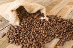 Roasted coffee beans in a bag on wooden background royalty free stock image Roasted coffee beans in a bag on wooden background royalty free stock image