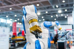 Robot Arm In A Factory Stock Photos Robot Arm In A Factory Stock Photos