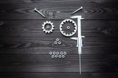 Robot face from gears tool and nuts on wooden background royalty free stock photo Robot face from gears tool and nuts on wooden background royalty free stock photo