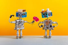 Robots de dates L'homme romantique de robot donne un bouquet des fleurs roses de roses à un robot femelle Service de rencontres o images stock Robots de dates L'homme romantique de robot donne un bouquet des fleurs roses de roses à un robot femelle Service de rencontres o images stock