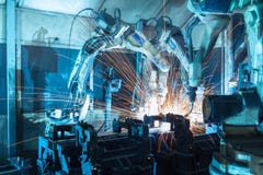 Robots welding in a car factory stock images Robots welding in a car factory stock images