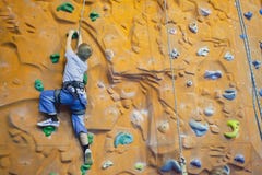 Rock-climbing boy with help stock photo Rock-climbing boy with help stock photo