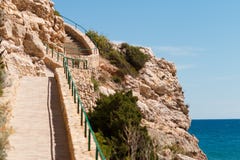 Rocky seashore. Stone staircase on the mountainside. Picturesque sea landscape. Summer seascape. Spain Royalty Free Stock Photography Rocky seashore. Stone staircase on the mountainside. Picturesque sea landscape. Summer seascape. Spain Royalty Free Stock Photography