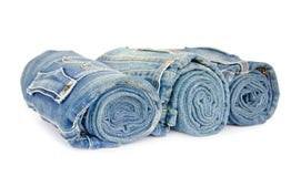 Roll blue denim jeans arranged on white background stock photography Roll blue denim jeans arranged on white background stock photography