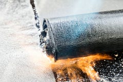 Roll roofing Installation with propane blowtorch during construc royalty free stock photo Roll roofing Installation with propane blowtorch during construc royalty free stock photo