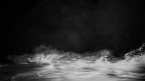 Rolling Billows Of Smoke Mist Clouds From Dry Ice Across The Bottom Light . Fog On Floor Isolated Background Black Texture . Stock Photography